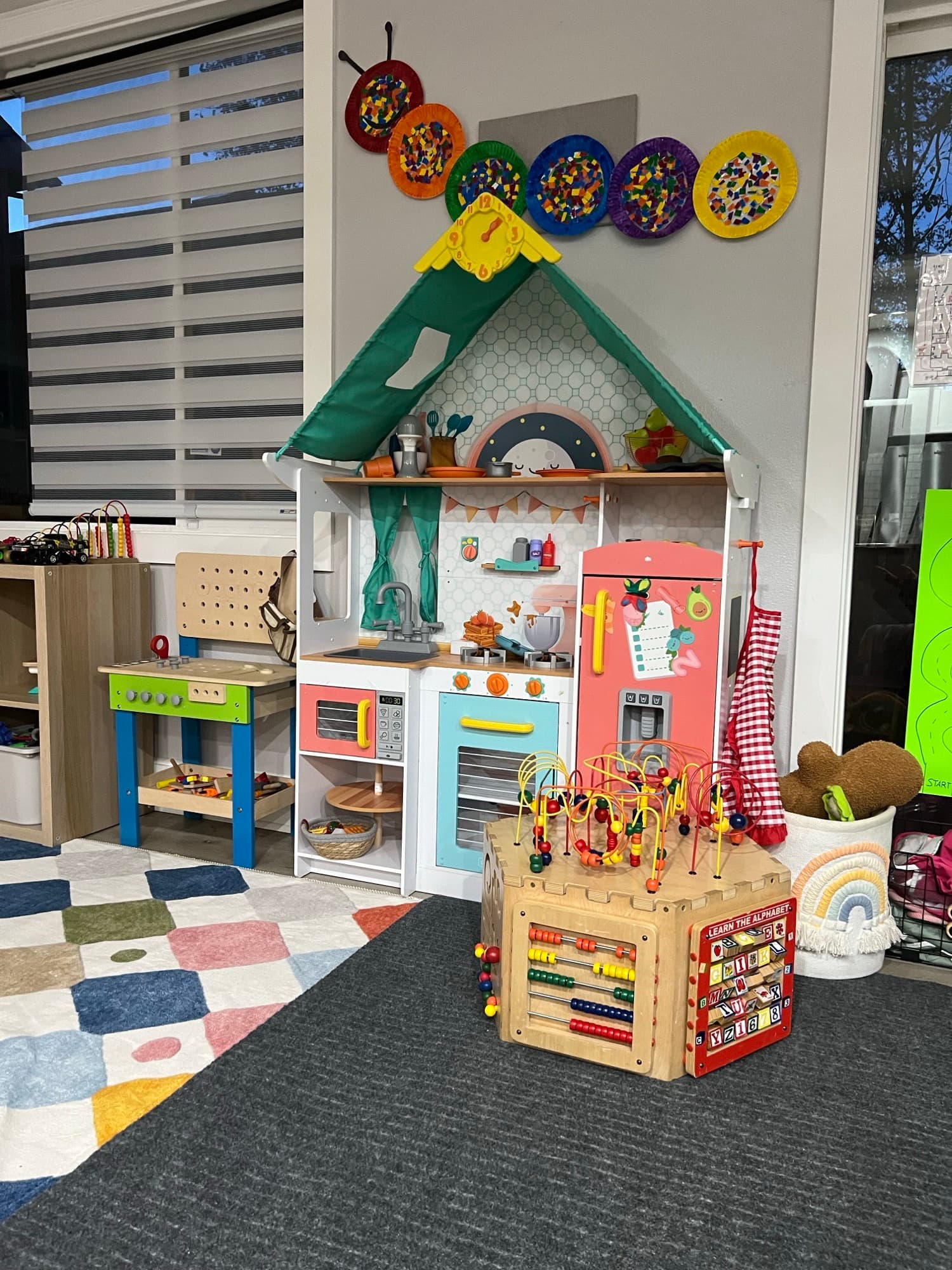 The play kitchen, abacus, and sensory wall